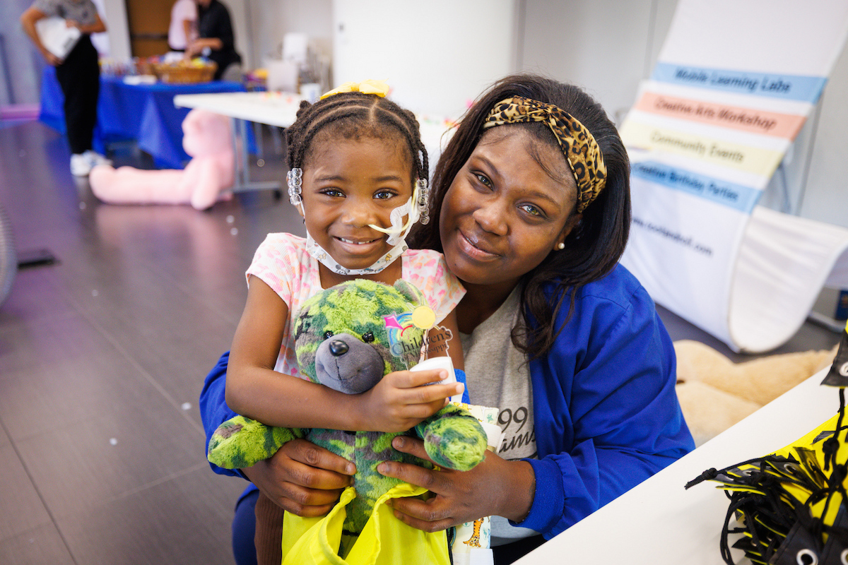 Pailyn Williams, 5, of Crystal Springs and her mom, Patience, pose with her new bear at Toot, Teach and Roll's third annual Furry Friends event at the children's hospital.